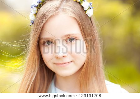 Smiling baby girl 12-14 year old posing outdoors. Looking at camera. Childhood.