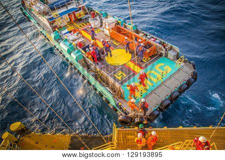 crew boat receive and transfer passenger to oil and gas processing platform at boat landing