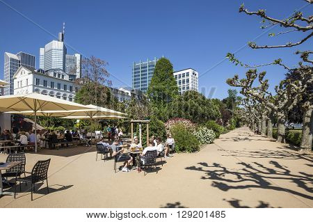 People Relax At The Bank Of River Main In Nizza Gardens