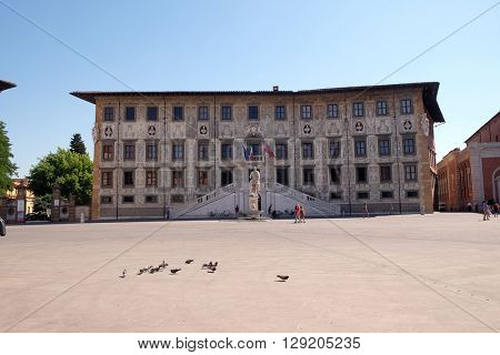 PISA, ITALY - JUNE 06, 2015: PISA, ITALY - JUNE 06, 2015: Building of Pisa Superiore University on Piazza dei Cavalieri (Palazzo della Carovana) decorated with frescos, in Pisa, Italy on June 06, 2015