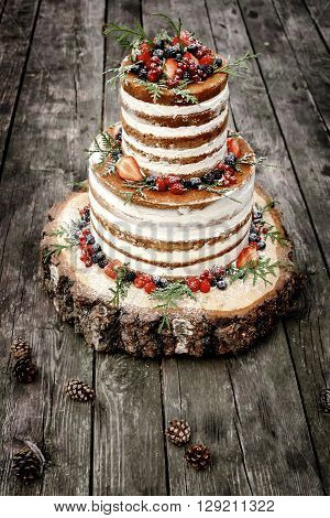 wedding cake in rustic style with berries
