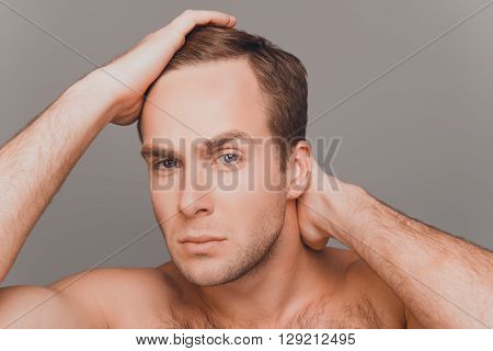 Portrait Of Young Man Combing His Hair With Fingers