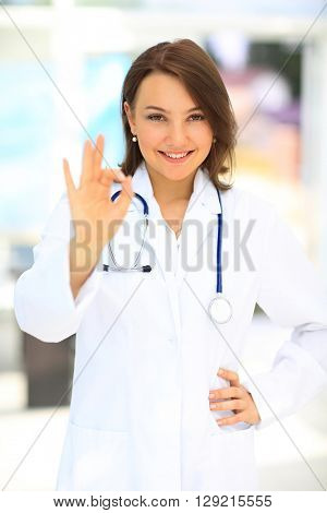 A female doctor shows a sign okay