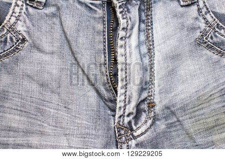 open fly low blue jeans texture background closeup