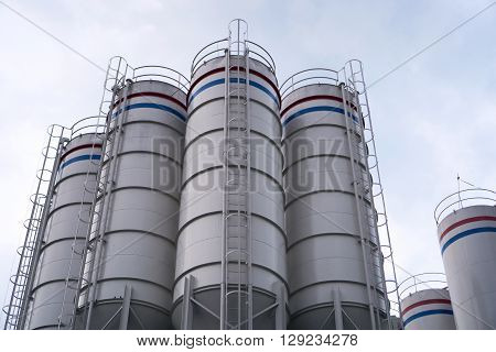 Tank of industrial process with sky background.