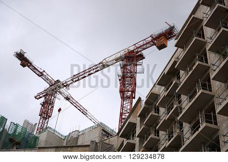 Construction site with cranes on sky background