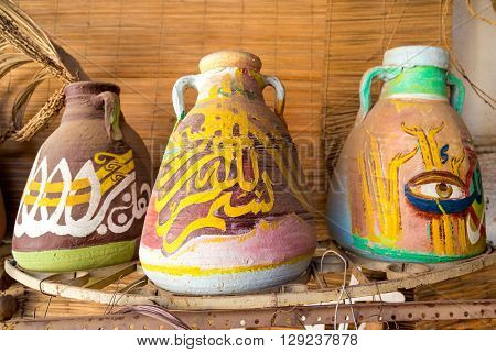 DARAW, EGYPT - FEBRUARY 6, 2016: Decorative colorful pottery in Palm tree decoration gallery.