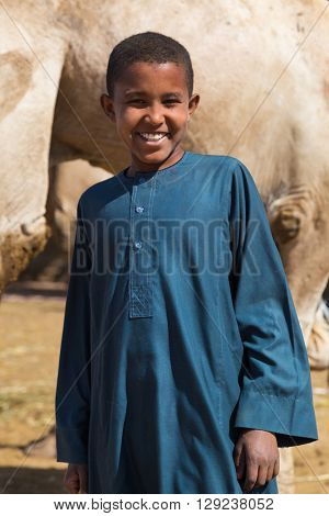 DARAW, EGYPT - FEBRUARY 6, 2016: Local young camel salesmen on Camel market posing for camera.