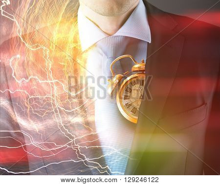 Concept of time with businessman in suit and clock