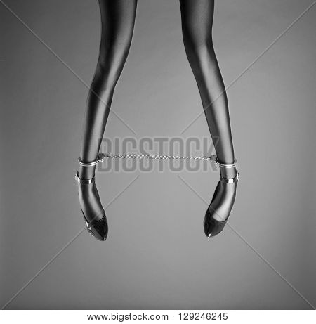 Beautiful woman legs with ankle cuffs and high heels