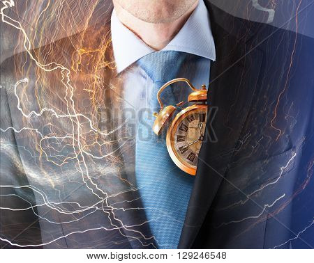 Concept of time with businessman in suit and clock