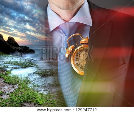 Concept of time with businessman in suit and clock