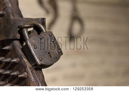 Close-up Of Iron Padlock Of Ancient Torture Chair In Sunlight