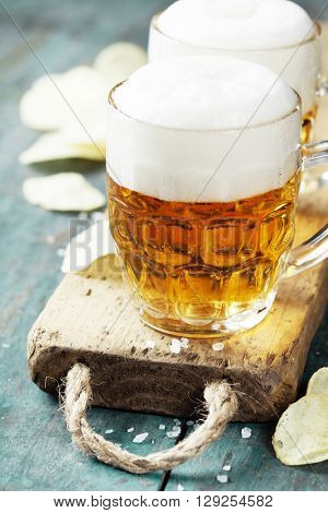 Beer and Potato Chips on vintage wooden table