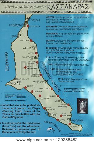Pefkohori, Greece - May 1, 2016: Image of the symbols and drawings, Greek letters on the poster. Schematic map of the Kassandra peninsula, the symbols of towns and attractions. Located on Main Street, Pefkohori, 63085, Greece