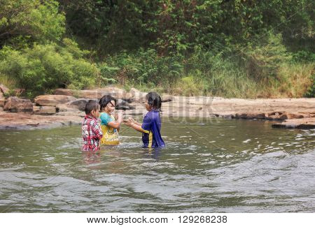 PHITSANULOK THAILANDFEBRUARY 2016 Group of childern play happily in water at KHEK RIVER