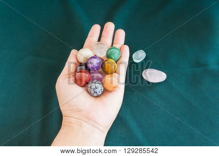 Colourful round stones in hand quartz gem