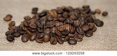 Coffee beans on burlap background close up
** Note: Shallow depth of field
