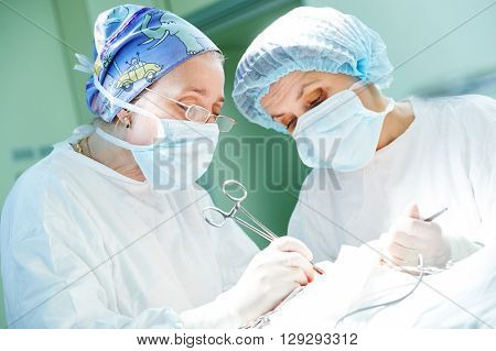 surgeons at work. female doctors operating in child surgery hospital