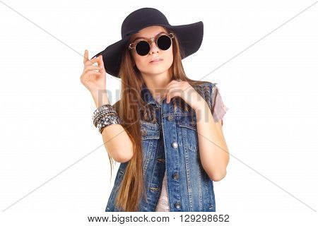 girl in black hat and sunglasses posing in the studio, fashion concept