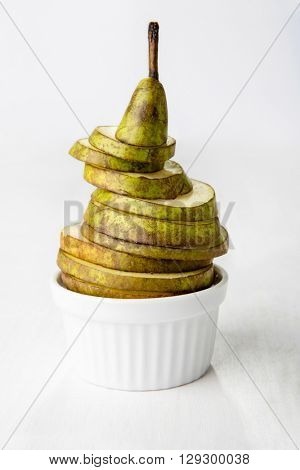 Sliced pear in porcelain dish