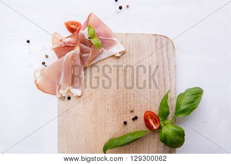 Black forest ham on wooden cutting board