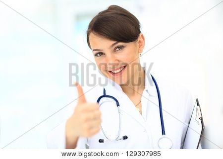 A female doctor shows a sign okay