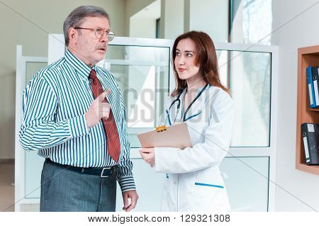 patient listening to his doctor in medical office. Healthcare concept
