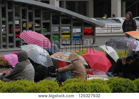 ANKARA/TURKEY-MAY 8, 2016: Spectators at the Sinpas Altin Oran Square during the 20. International Ankara Jazz Festival with umbrellas. May 8, 2016-Ankara/Turkey