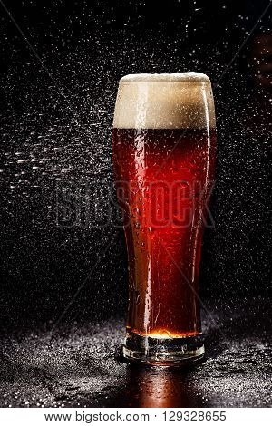 Beer Glass With Drops On Black. Fresh! Much Foam! Beer Bubbles Closeup. Draft. Overflow Beer Glass.