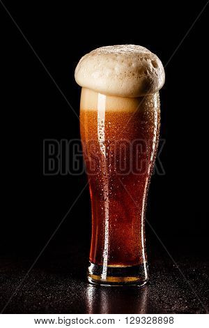 Beer Glass With Drops On Black. Fresh! Much Foam! Beer Bubbles Closeup. Draft. Overflow Beer Glass.