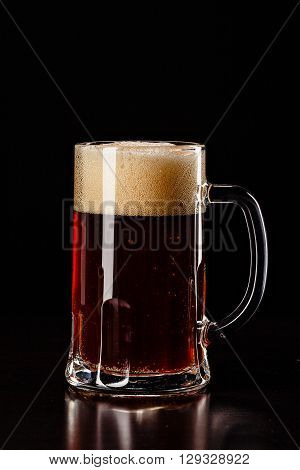 Beer Glass With Drops On Black. Fresh! Much Foam! Beer Bubbles Closeup. Draft. Overflow Beer Glass.