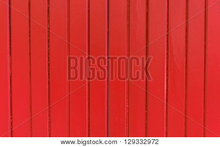 Clos up red painted corrugated wood door