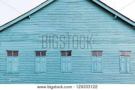 Five Windows on old wooden house Painted bright blue