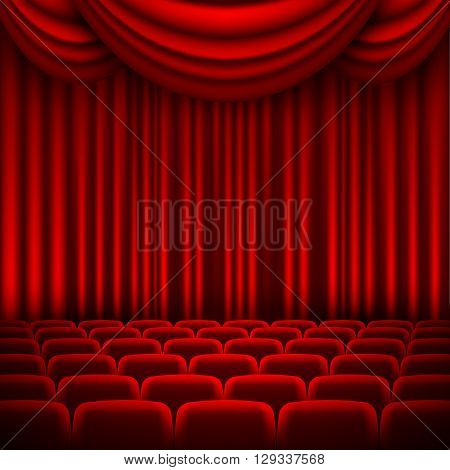 an auditorium with a seating area and a red curtain