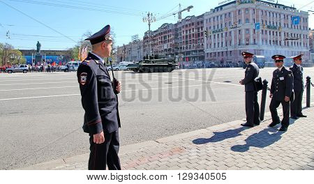 MOSCOW RUSSIAN - MAY 9 2013: Policemen in cordon wait for motorcade on TverskayaStreet on parade devoted to devoted to Victory Day. For editorial use only.