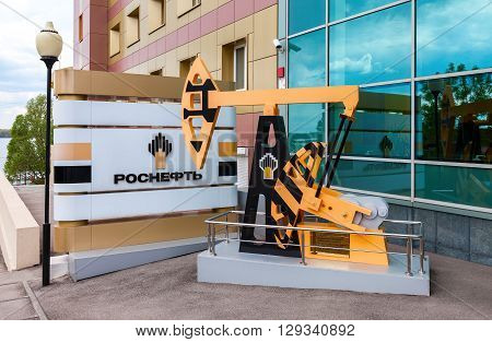 SAMARA RUSSIA - MAY 8 2016: Oil industry equipment. Model of Oil pump jack near the office building of the russian oil company Rosneft in Samara