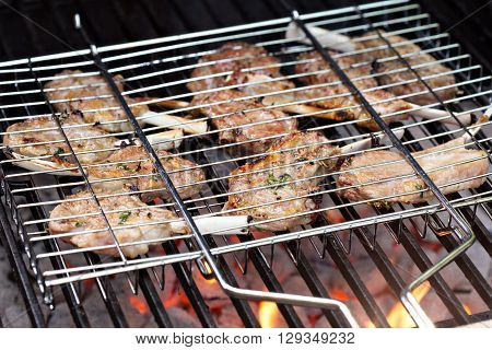 Lamb chops in grilling basket cooking on grill