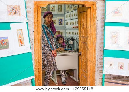 Buckara Uzbekistan - Aprilr 15 2014: Two ladies in a shop of the craft market