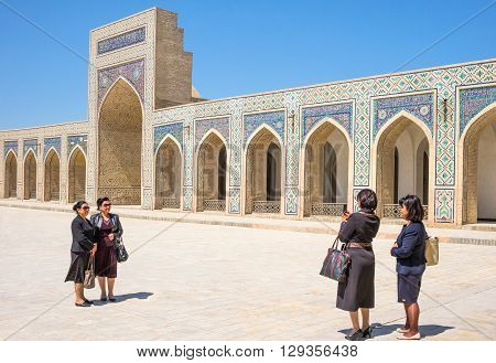 Buckara Uzbekistan - Aprilr 16 2014: Local women in the inside square of the Kalon mosque