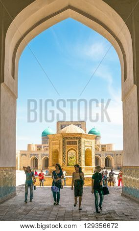 Buckara Uzbekistan - Aprilr 16 2014: Local women leaving the square of the Kalon mosque