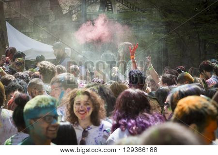 NEW YORK - APR 30 2016: People celebrating Holi Hai Festival of Colors with colorful powder on their faces in Dag Hammerskjold Plaza hosted by NYC Bhangra in New York on April 30, 2016.