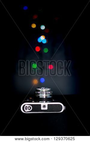 rangefinder camera on back with bokeh fairylights