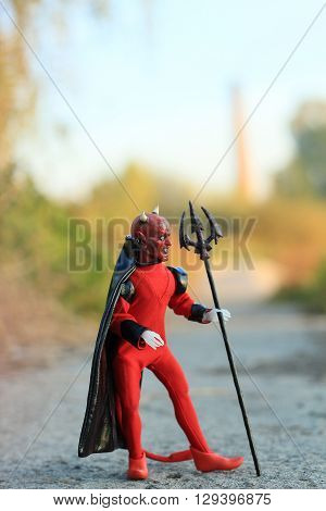Doll of Devil with forks on the road