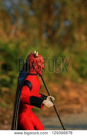 Doll of Devil with forks on the road