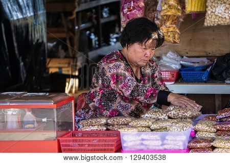 Ranau,Sabah,Malaysia-Nov 12, 2015:Local woman selling various local food product at a local market called 'Tamu' in Ranau,Sabah,Malaysia.Tamu is very famous in Sabah of Borneo for purpose of business
