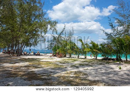 CRABI PROVINCE THAILAND - FEBRUARY 02 2015: Tourists relaxing on the white sand beach of Andaman sea at Krabi province Thailand