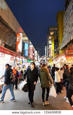 TOKYO- APRIL 1, 2016: People shopping in the Ameyoko shopping street in Ueno district ,Tokyo Japan. This market is various products such as clothes, bags, cosmetics, fresh fish, dried food and spices are sold along Ameyoko.