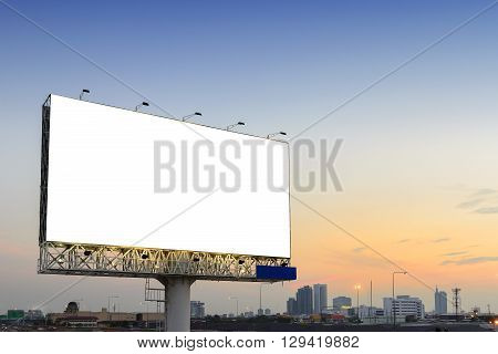the empty advertisement board beside the highway road with the twiglight scene