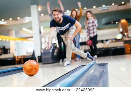 Friends having fun while bowling and speding time together